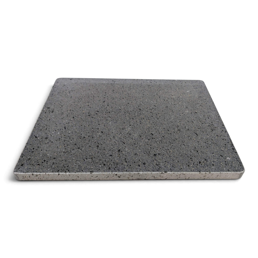 A rectangular lava pizza baking stone with a speckled look, shown from above at a on a white background.