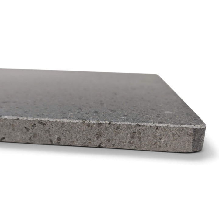 A close up side view of the lava stone pizza cooking stone corner with rounded edge.