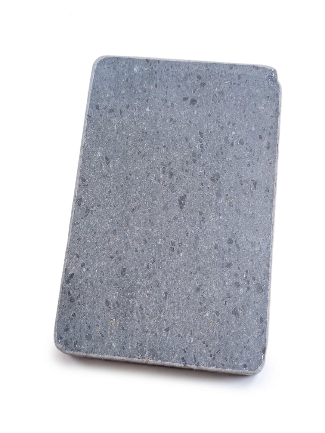 Top view of rectangle lava cooking stone with curved edges on a white background.