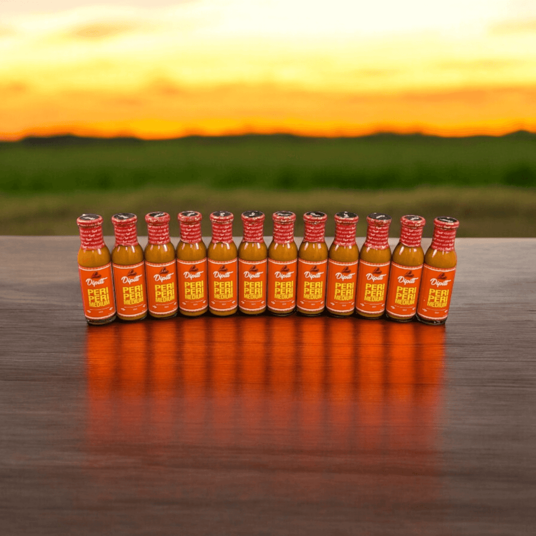 Dipitt Peri Peri Medium, lined up with a sunset background