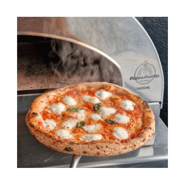 Close-up view of a freshly baked pizza being removed from an Emozione outdoor pizza oven.