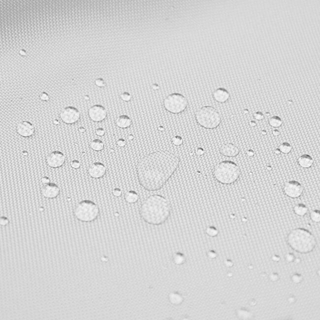 Close-up of the light gray textured material of the Pizza Party Oven covers with scattered clear water droplets showing a water-repellent finish.