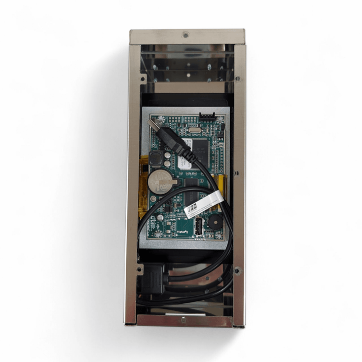 A top-down view of an open Black Rock Grill Digital Display Board for P134H Evo shows exposed circuitry, a motherboard, a coin cell battery, and a coiled black USB cable inside the metal case against a white background.