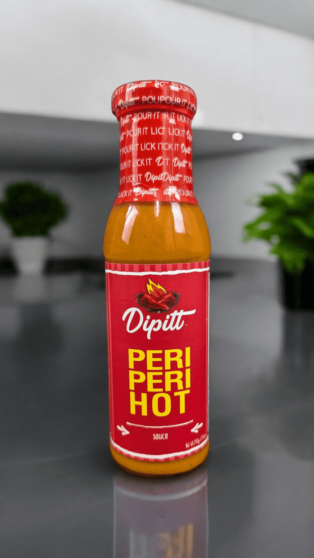 Dipitt Peri Peri Hot Sauce, 300g bottle  in a kitchen