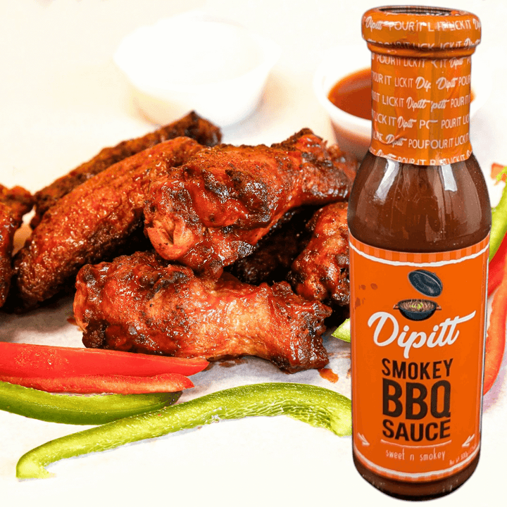 Dipitt Smokey BBQ Sauce, Sweet and smokey 300g glass bottle of sauce with chicken wings in the background