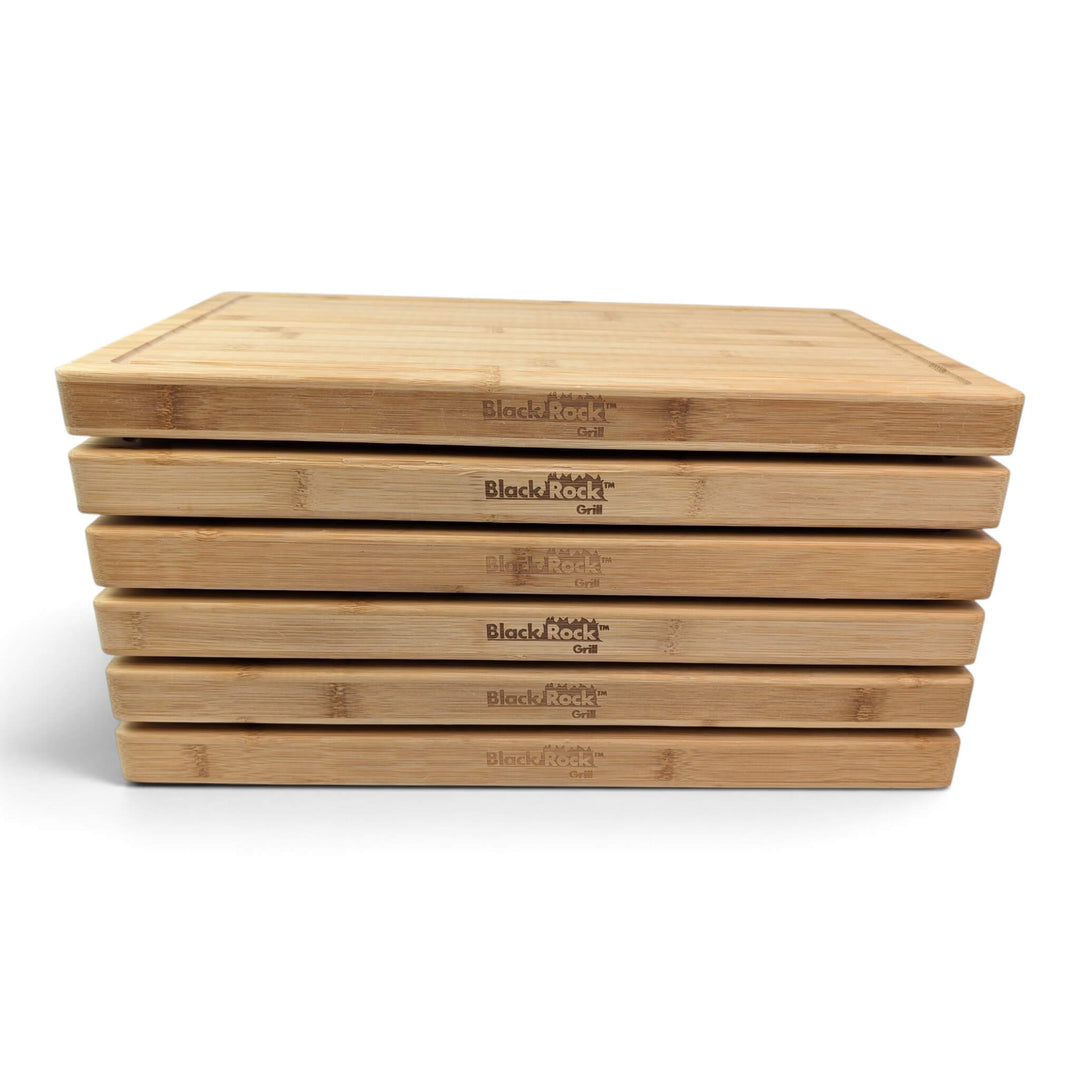 Head-on front view of 6 stacked Black Rock Grill bamboo chopping boards showing uniform thickness.