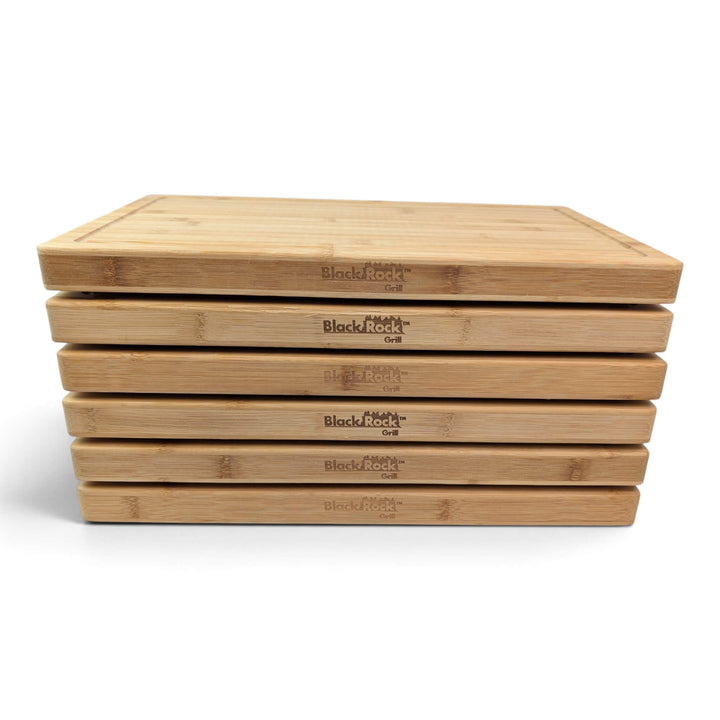 Head-on front view of 6 stacked Black Rock Grill bamboo chopping boards showing uniform thickness.