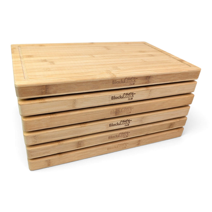 Left side view of a stack of 6 sustainable bamboo chopping boards for catering and wholesale.