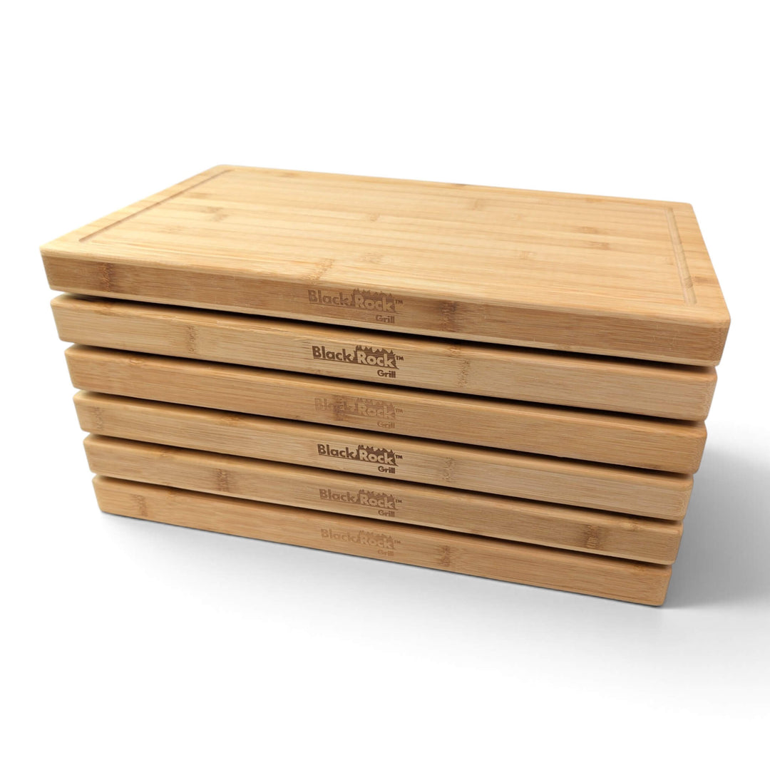 Right side view showing a pack of 6 stacked bamboo serving boards with smooth finished edges.