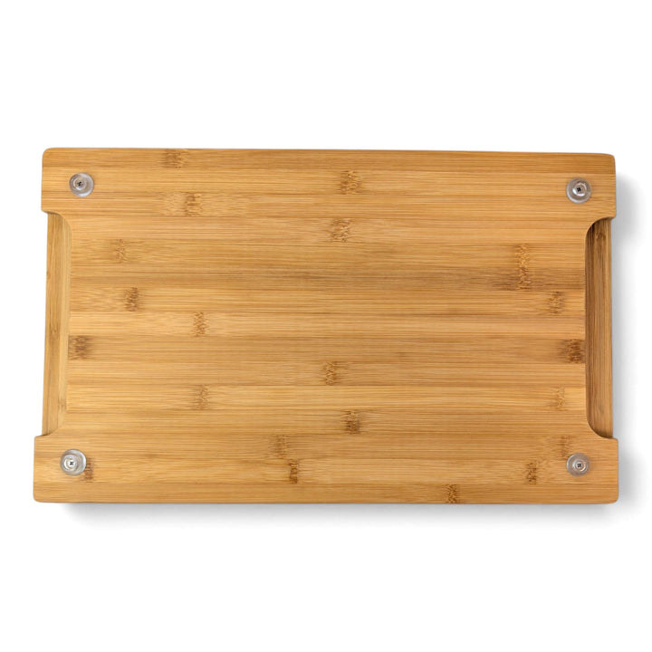 Underside view of a bamboo chopping board showing non-slip rubber feet and indented side handles for easy lifting.