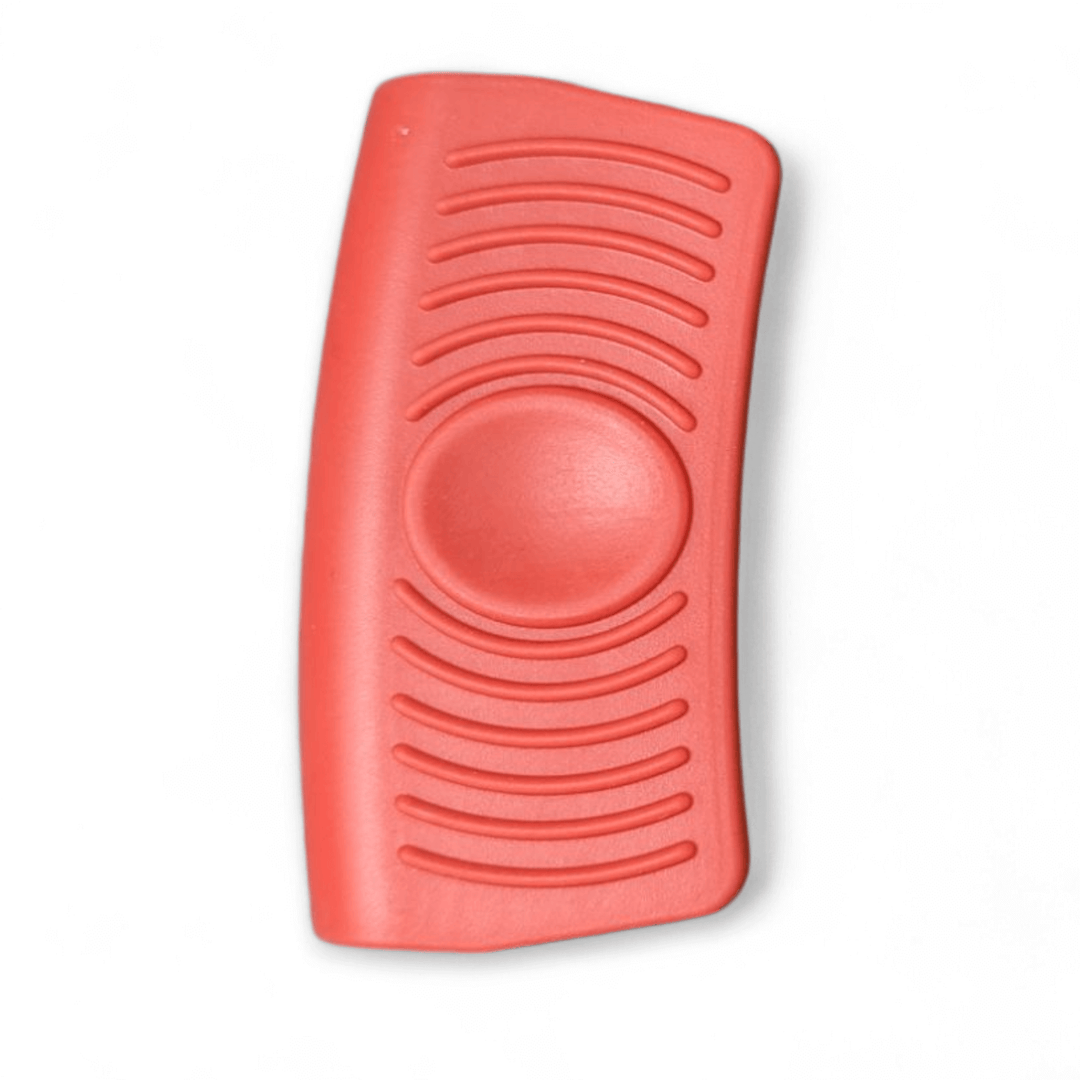 The Black Rock Grill Silicone Heat Resistant Handle Holder Covers are red, rectangular objects with curved edges made from food-grade silicone. They feature wavy ridges along the longest sides and a large circular indent in the center.