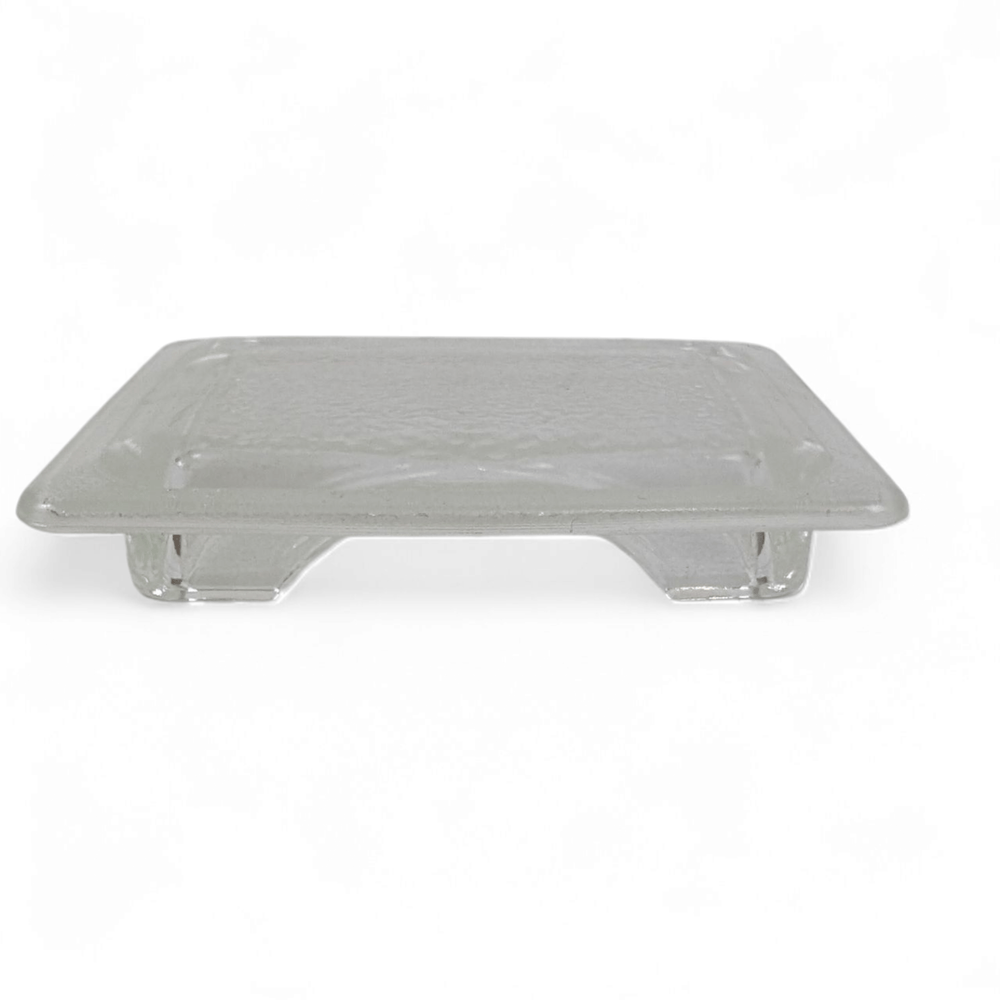 Clear square plastic cap or cover with rounded corners and two small leg supports on the bottom, shown on a white background—ideal as a Genuine Effeuno Flat Lamp Shade Glass Cover & Fitting, perfect as an Effeuno spare part for your pizza oven.