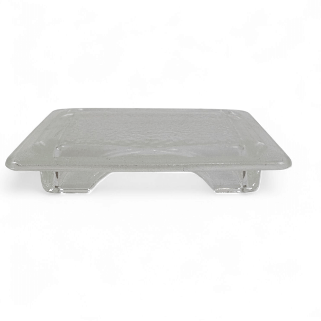 The Effeuno Lamp Shade Glass - Flat Fitting by Effeuno is a clear, rectangular glass tray with slightly raised edges and short legs, shown against a white background.