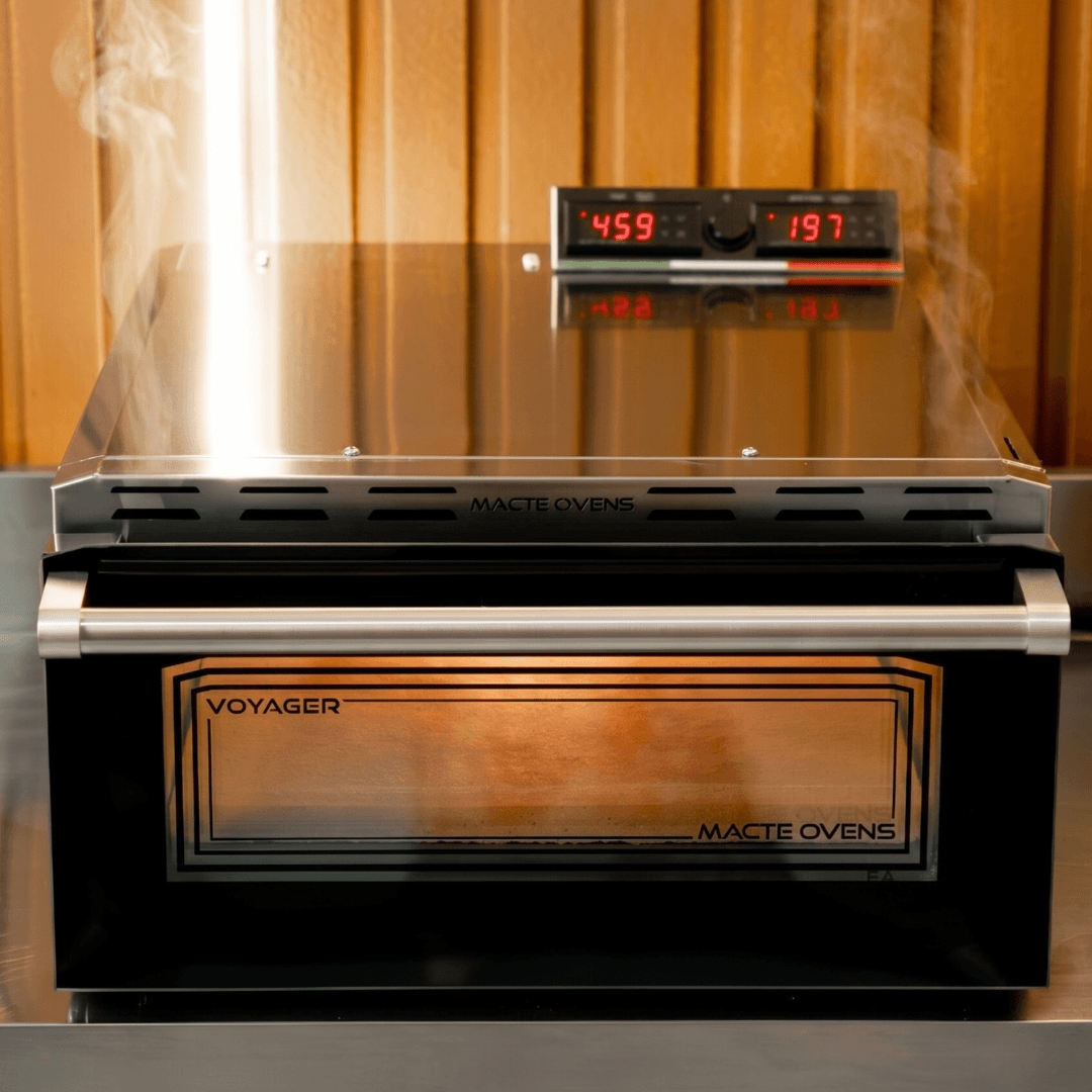 Front view of the Macte Voyager Advanced pizza oven turned on and ready to cook.