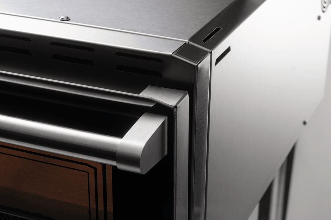 Close-up of the front right corner and sturdy door handle on the Macte Voyager Twin Advanced, highlighting the premium stainless steel build.