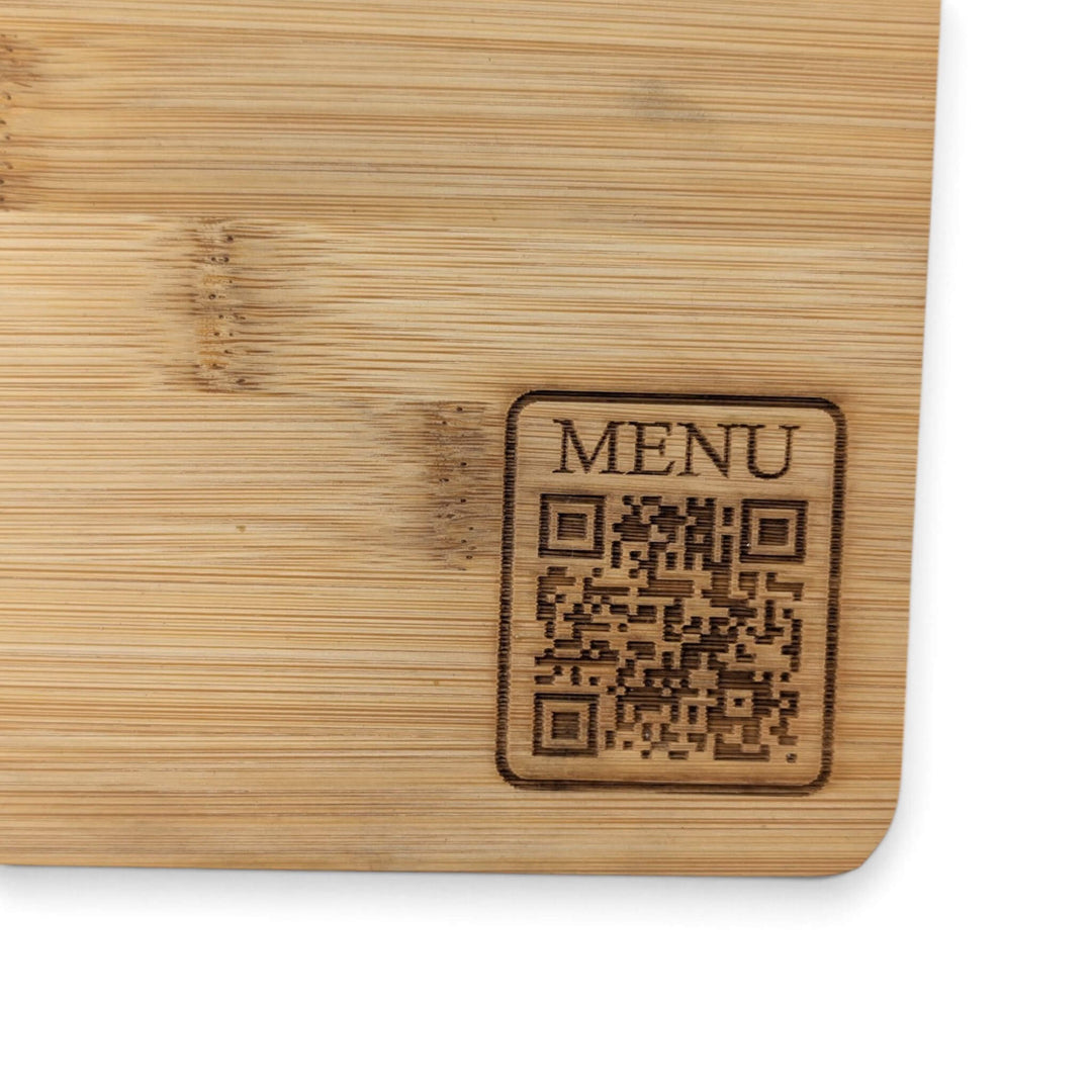 A Bamboo Serving Steak Board (30x20x1.2cm) from Black Rock Grill with a custom laser-engraved QR code and the word "MENU" in the corner, designed for easy digital menu access when scanned.