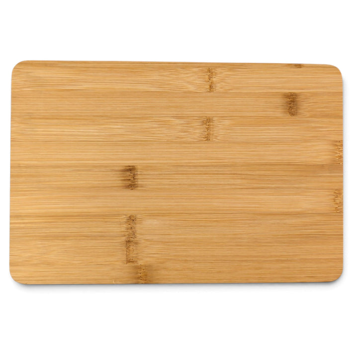 The Black Rock Grill Bamboo Serving Steak Board (30x20x1.2cm) is a rectangular bamboo board with rounded corners, displayed on a white background. Featuring a natural wood grain pattern accented by subtle darker patches, it makes an elegant and versatile choice for serving steaks or appetizers. Custom laser engraving is available to personalize this essential kitchen board.