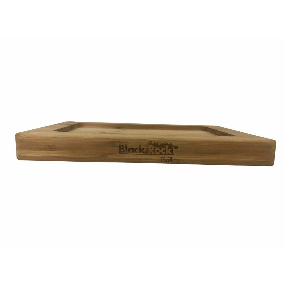 The Black Rock Grill logo enhances the GP-28 Bamboo Board, made from sustainable bamboo with rounded edges and a recessed surface. Seen from a low angle on a white background, it merges style and functionality. Comes in cases of 12 for the Hot Steak Stones Cooking Rock Set.